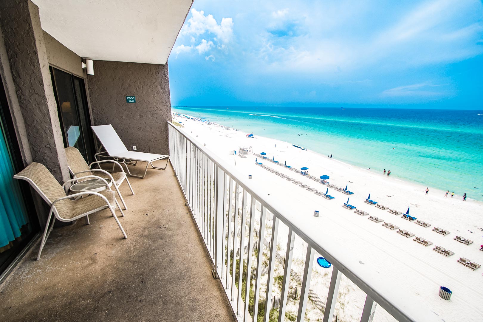 A relaxing view of the beach from the balcony at VRI's Landmark Holiday Beach Resort in Panama City, Florida.